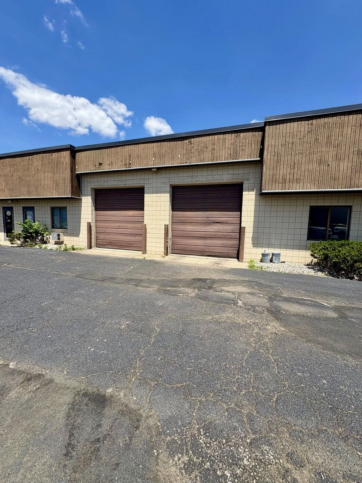 Commercial building with two white overhead doors
