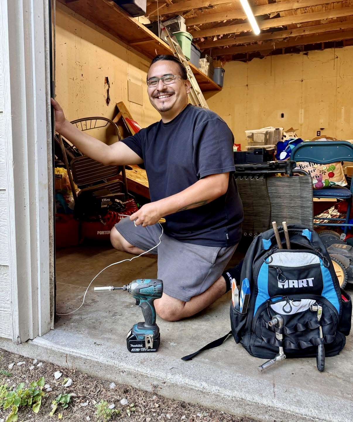 Daniel of Alpine Garage Doors working with tools at a residential garage