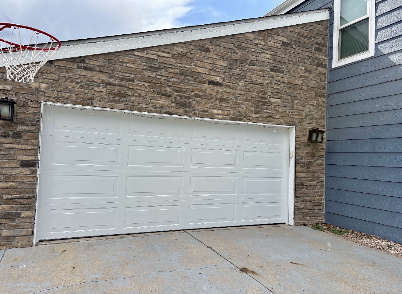 White raised-panel garage door after replacement