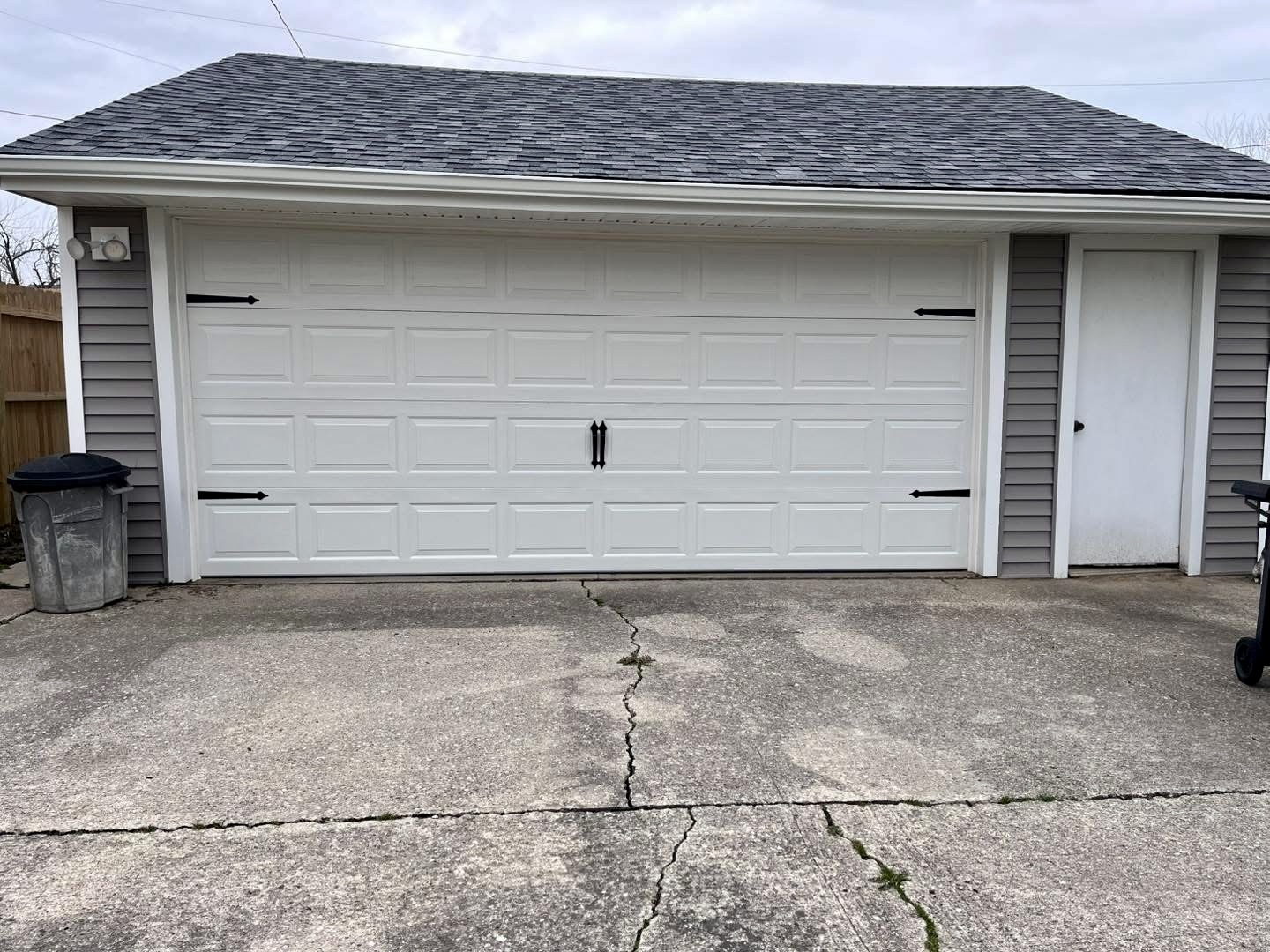 White detached garage door with carriage-style hardware